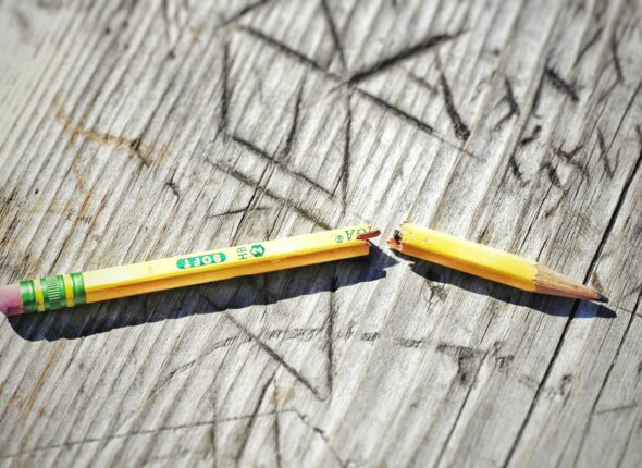 yellow pencil on gray wooden surface